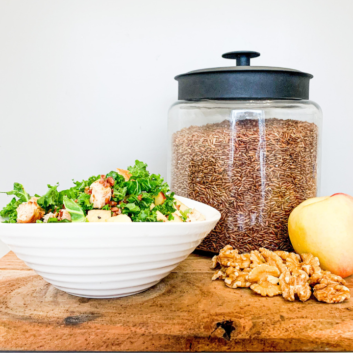 rice in a canister and salad in a bowl on counter